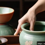 고려 청자와 조선 백자 비교 - A close-up of a master Korean potter’s hands shaping delicate celadon pottery on a spinning wheel, s...