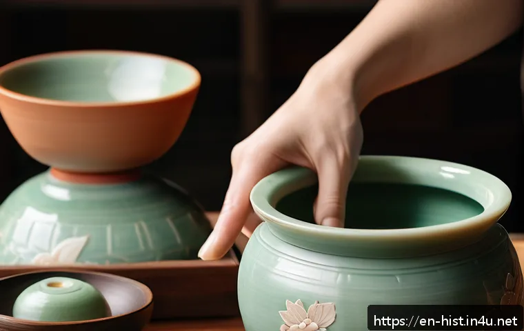 고려 청자와 조선 백자 비교 - A close-up of a master Korean potter’s hands shaping delicate celadon pottery on a spinning wheel, s...